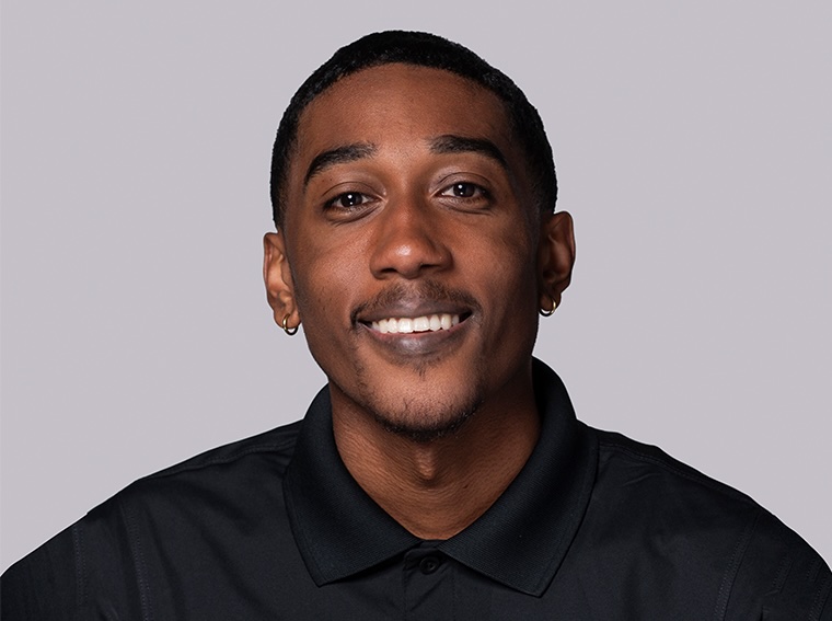 A young man smiles for the camera