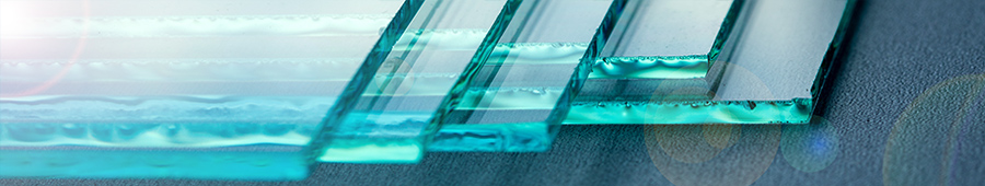 A close-up of several blue-green sheets of glass.