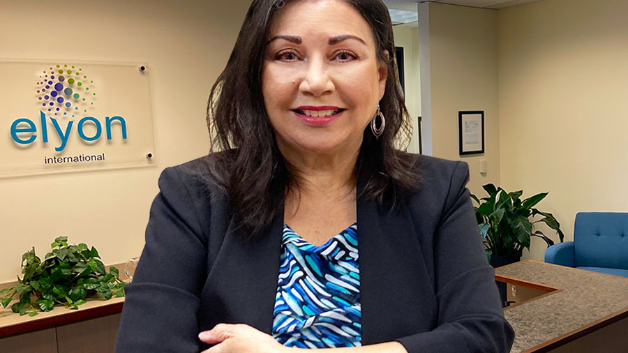 Carmen Nazario is pictured inside her ELYON International headquarters in Vancouver, Washington. The ELYON International logo appears over her right shoulder.