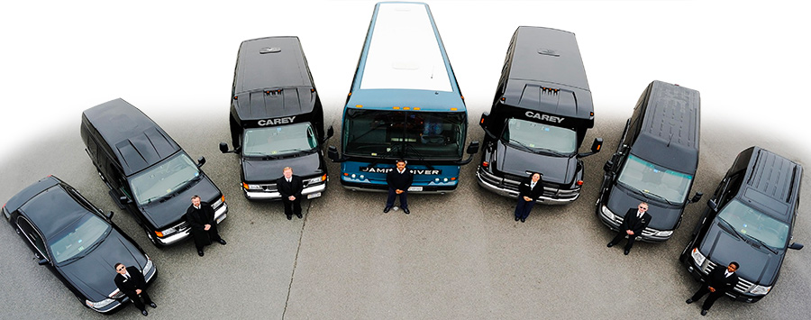 A range of buses, cars, and shuttle vans arranged in a semicircle with drivers standing in front.