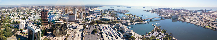 An aerial view shows Long Beach, California’s skyscrapers, buildings, roads, and water.