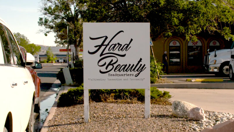 A curbside sign reads “HardBeauty Headquarters — Cultivating connection and community.”