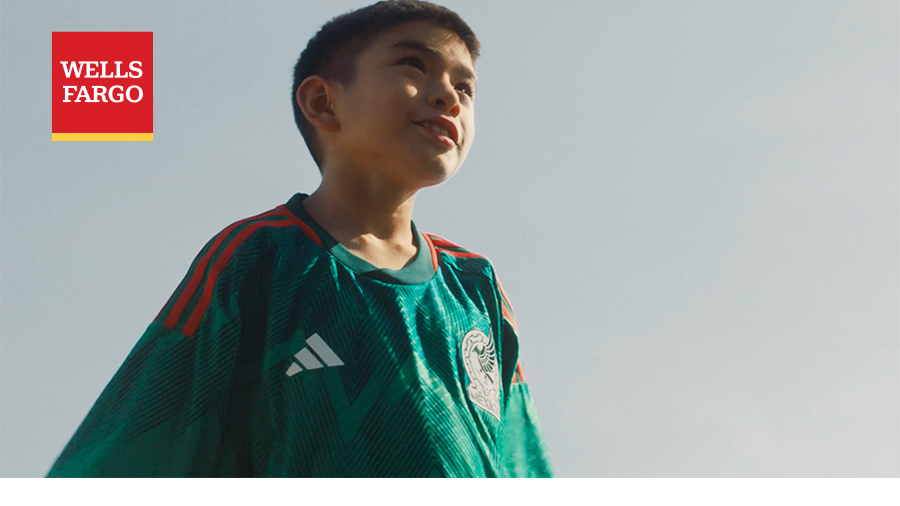 A person wears the Mexico national football team kit. The Wells Fargo logo is in the upper-left corner of the photo.