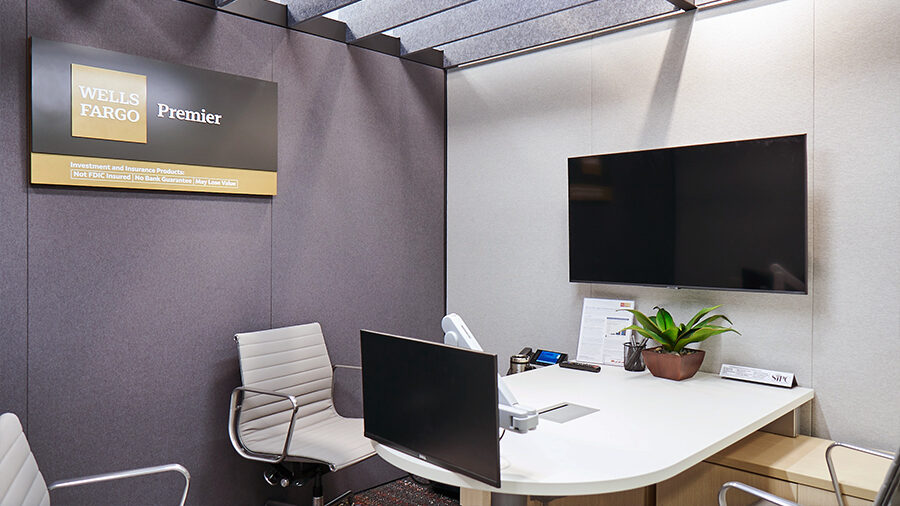 An office with Wells Fargo Premier signage has TV screens for presentations between Premier teams and their clients.