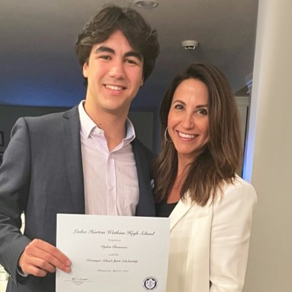 Jenny Brosseau stands with her son who is holding his high school diploma