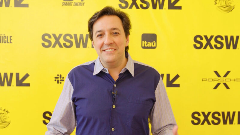 Dario Gil stands in front of a SXSW backdrop