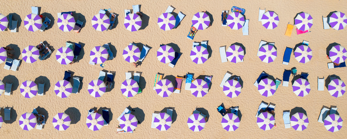 An overhead shot of rows of beach umbrellas