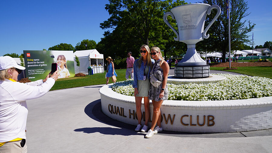 Two people pose for a photo at the Quail Hollow Club.