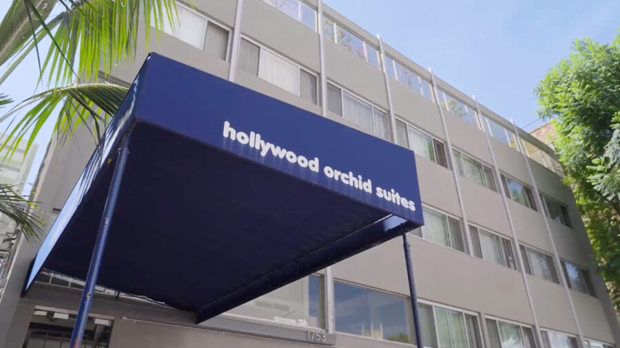 The Orchid, a Project Homekey housing project, still shows signs of its former life as the Hollywood Orchid Suites hotel, such as an awning with the former name.