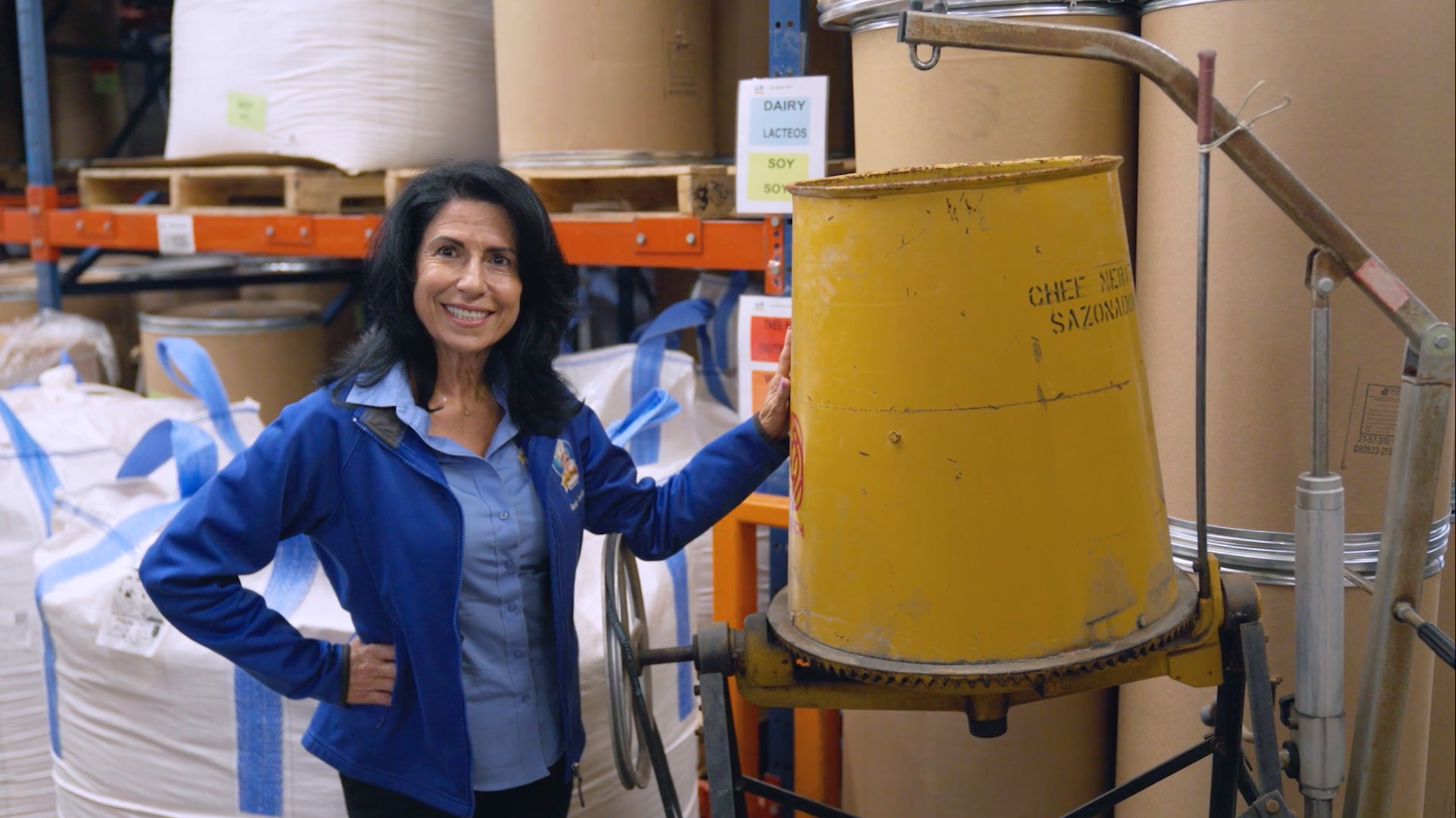 Ambar Corugedo, Owner of Chef Merito, stands by her father's original industrial mixer.