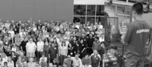 A black and white photo shows company employees standing together. On the right is an image of person wearing a Harken T-shirt.
