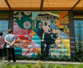 People gather and admire a mural