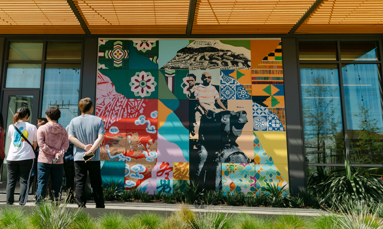 People gather and admire a mural