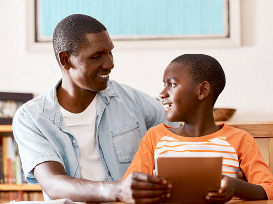 A father and son smile at each other
