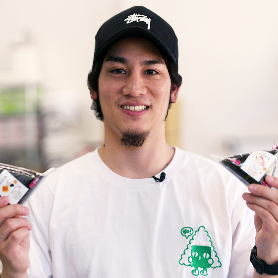 A man in a black baseball cap and white t-shirt