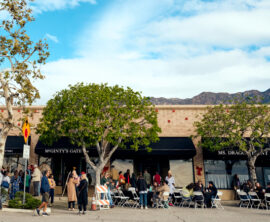 A group of people stand together at an outdoor LA Wildfire relief event.