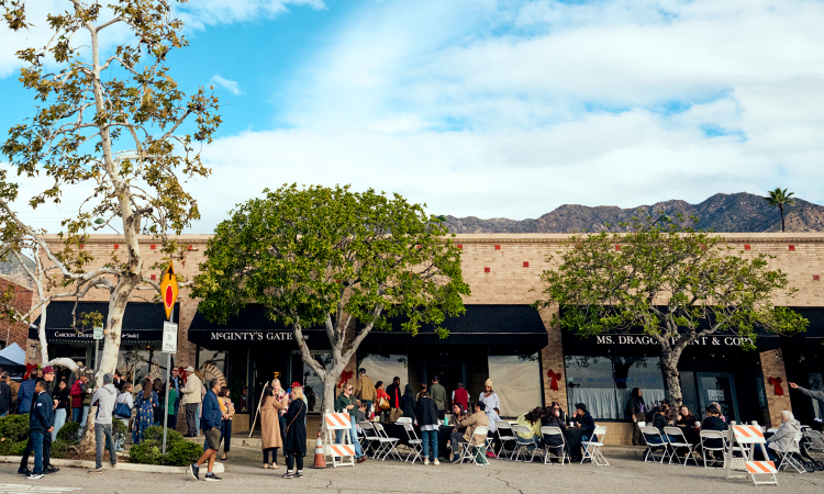 A group of people stand together at an outdoor LA Wildfire relief event.