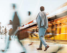 Abstract photo of a person walking by the interior of a building