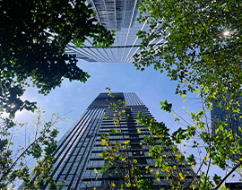 A photo taken looking up from the ground at high office buildings.