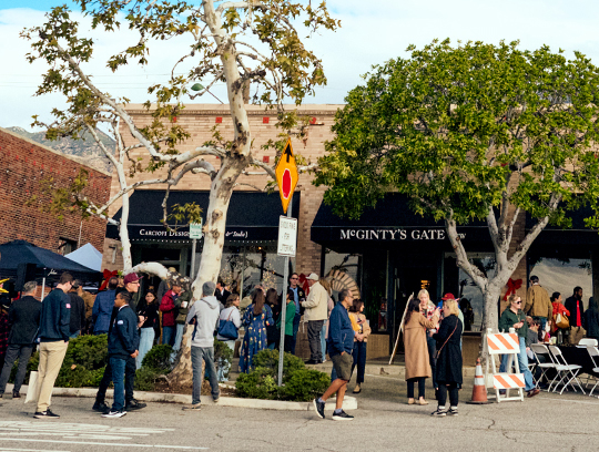 A group of people gather outside at an event.