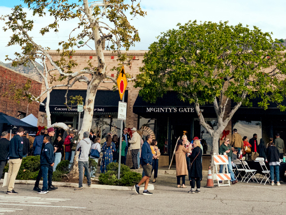 A group of people gather outside at an event.