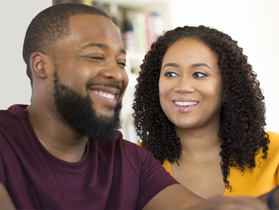 A couple looking at each other and smiling