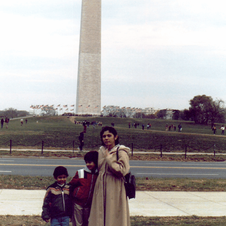 Rika Shah and her sons, Rajesh and Rupesh Shah, standing in front of the Washington Monument.