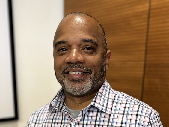 A man smiles at the camera