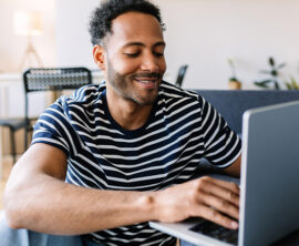 A man looks at a laptop screen