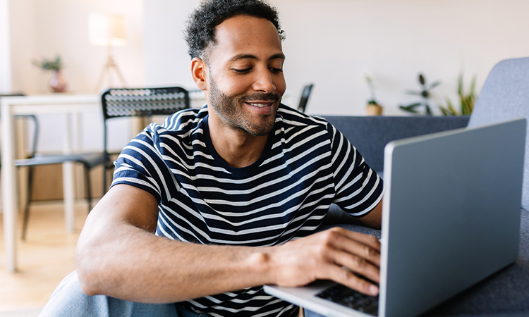A man looks at a laptop screen