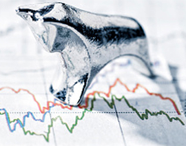 A bull figurine sits on top of a graph.