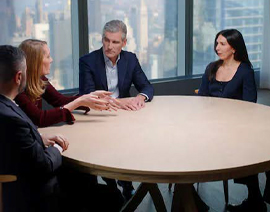 Coworkers sit around a table.