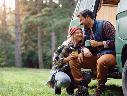 Two people snuggle by a fire