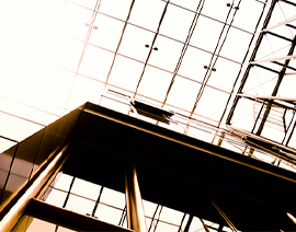 A camera shot looking up at the glass roof of a building.