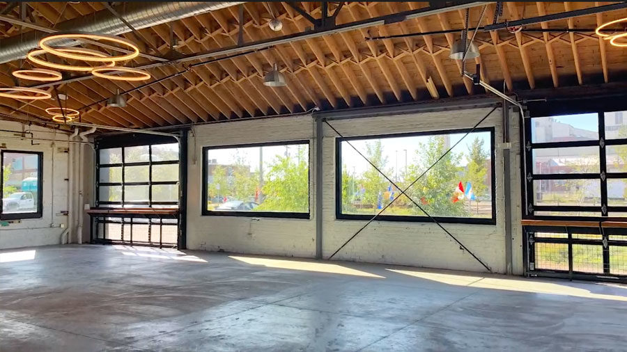 New large windows and ceiling lighting show the progression of the warehouse renovations.