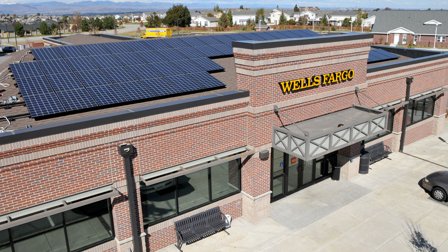 A color photograph showing the aerial view of a solar array on top of a Wells Fargo building.