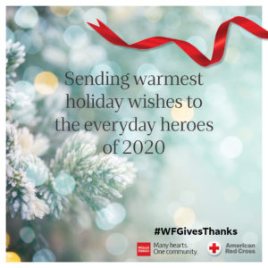 'Sending warmest holiday wishes to the everyday heroes of 2020' e-card text on a photo of a snowy Christmas tree. #WFGivesThanks, 'Many hearts. One community.', and Red Cross logos are on the bottom right.