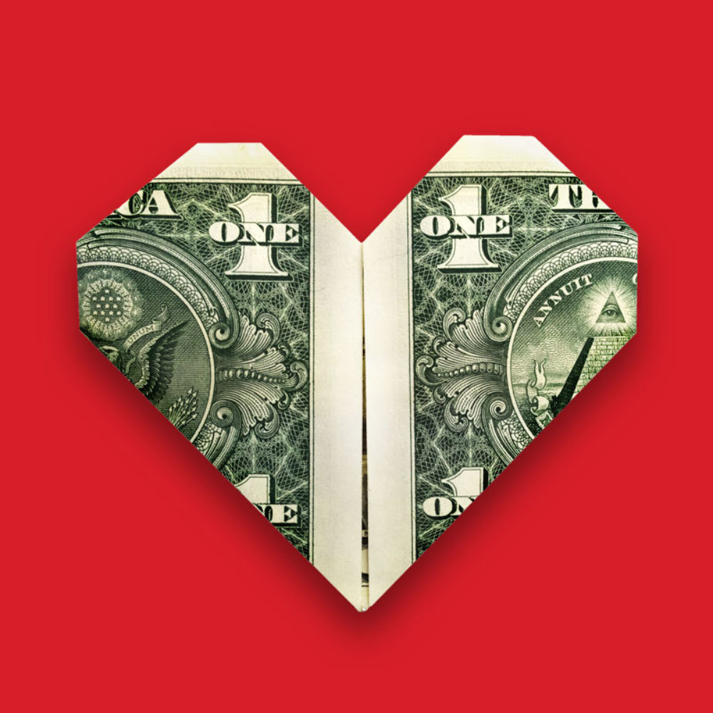 Una ilustración muestra un billete de un dólar estadounidense doblado en forma de corazón sobre un fondo rojo.