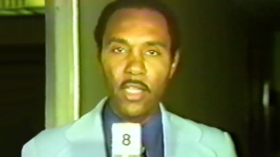 Roosevelt Toston, holding a Channel 8 microphone, reports from a Public Service Commission of Nevada hearing.