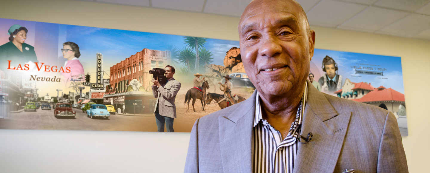 Roosevelt Toston stands in front of his image in the West Owens branch mural in Las Vegas.