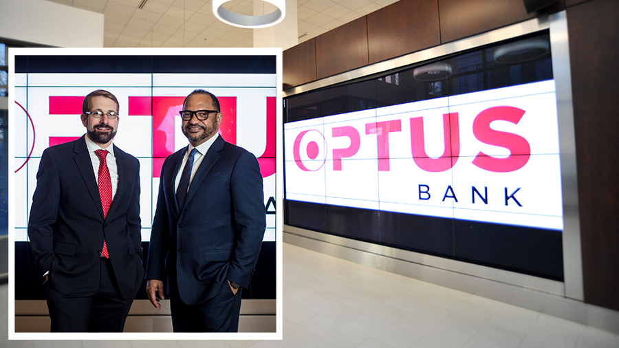 Interior shot of Optus Bank, with an image of Dominik Mjartan and Paul Mitchell standing in front of the bank's logo.