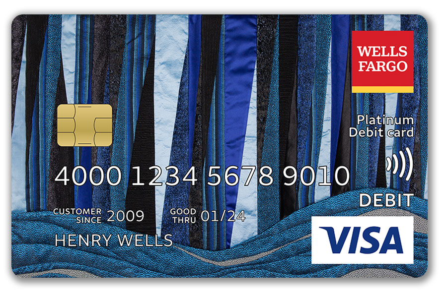 A Wells Fargo debit card features an art piece that uses blue and white fabric textures.