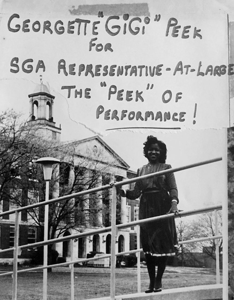 A black and white photo of Gigi Dixon. Handwriting on the photo says, “Georgette ‘Gigi’ Dixon for SGA representative-at-large. The ‘Peek’ of performance!”